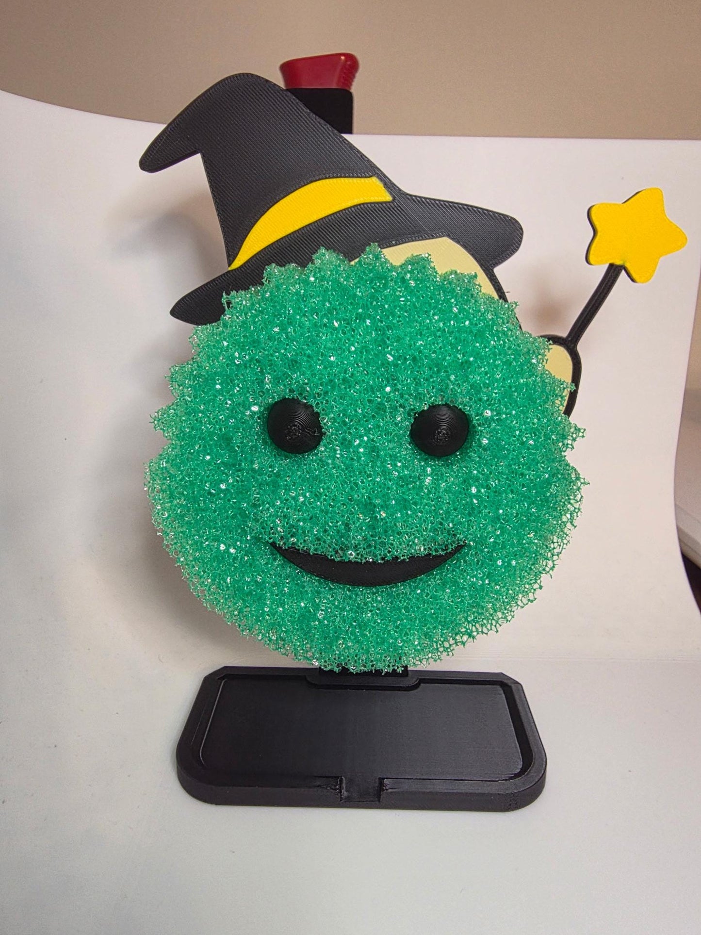 HoneyBunny3D Chick Witch Scrub Daddy holder holding a yellow Scrub Daddy sponge for kitchen cleaning.