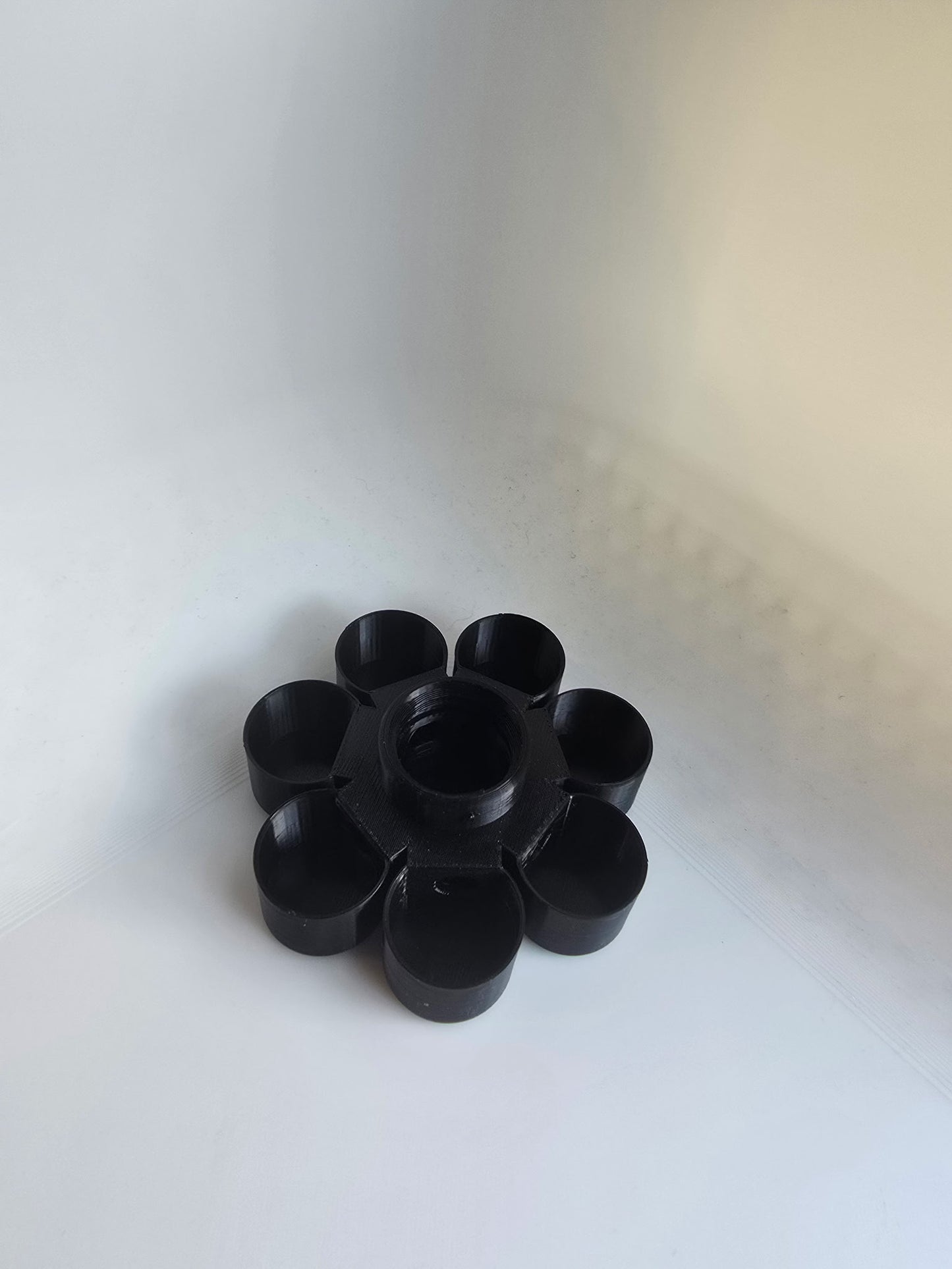 HoneyBunny3D Drinker Base for chicks and quail, durable plastic feeder for poultry watering, shown in natural setting.