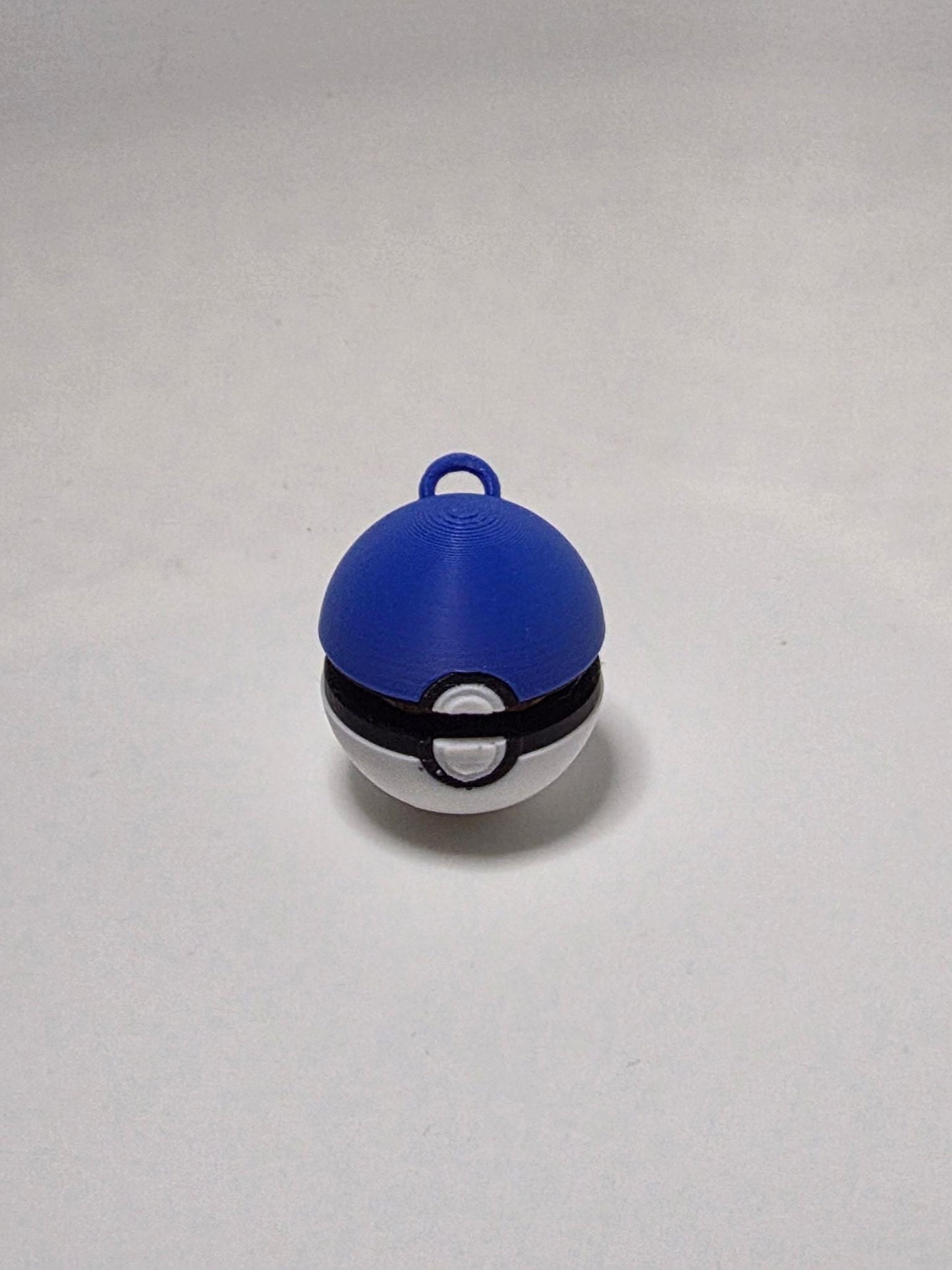 HoneyBunny3D PokeBall clicker fidget keychain charm with a realistic red and white design, perfect for stress relief and key organization.