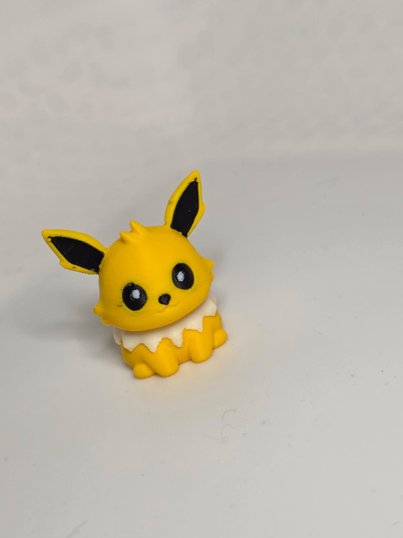MiniMon plush toy by HoneyBunny3D featuring a soft, colorful miniature monster with expressive eyes and a cuddly appearance.