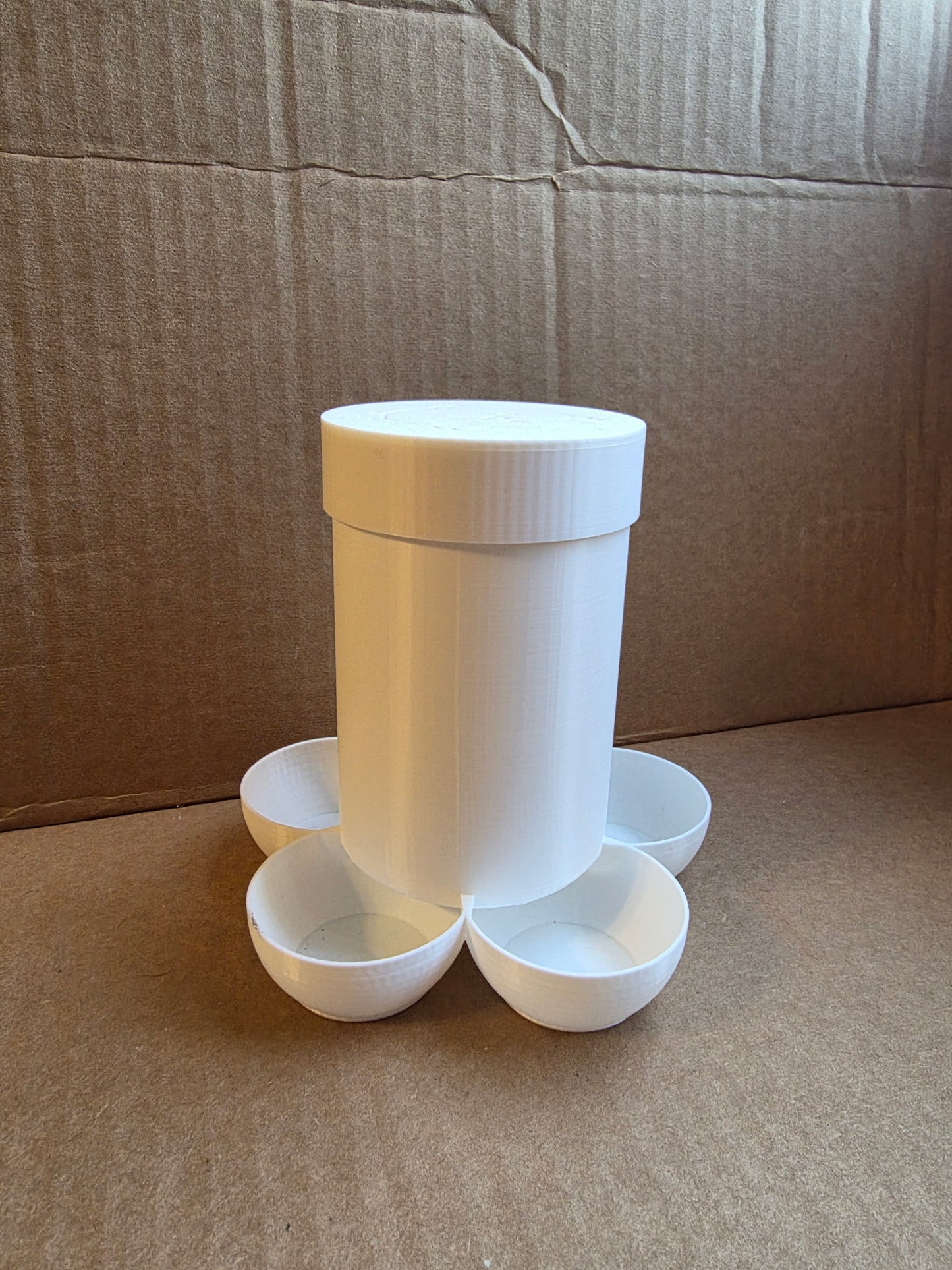 Small chick feeder by HoneyBunny3D with smooth plastic construction and multiple feeding ports for young poultry.