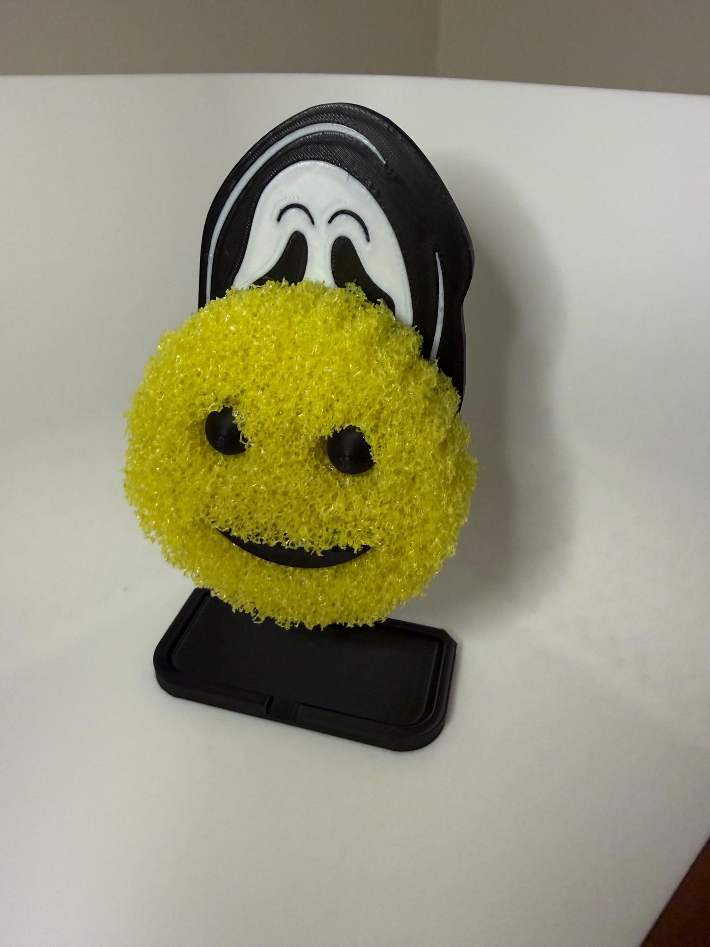 Ghost Face Scrub Daddy holder by HoneyBunny3D, featuring a spooky ghost face design with a place to hold cleaning sponges.