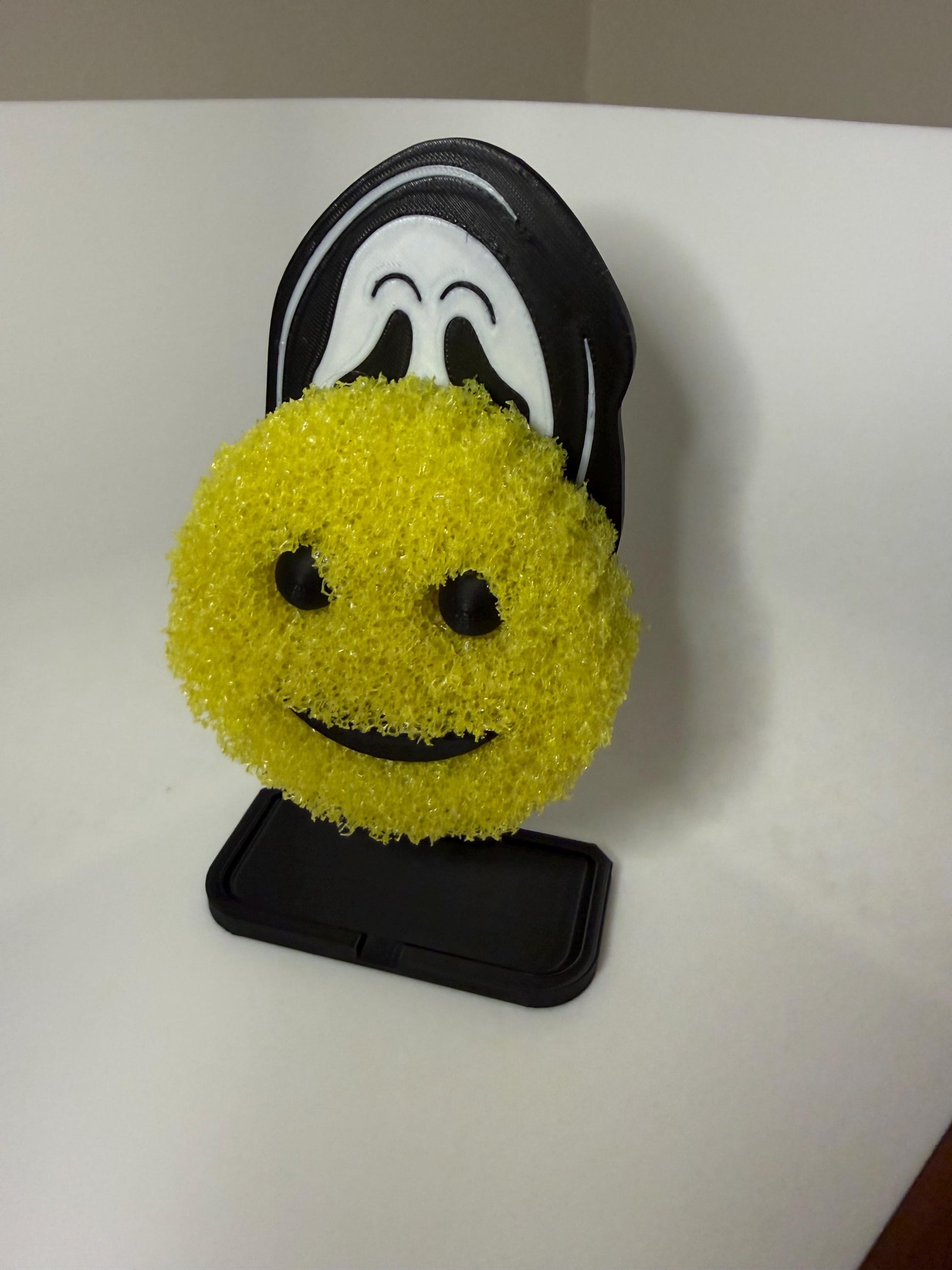 Ghost Face Scrub Daddy holder by HoneyBunny3D, featuring a spooky ghost face design with a place to hold cleaning sponges.