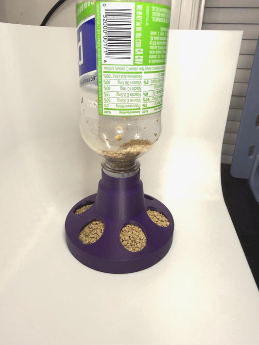 HoneyBunny3D chick and quail feeder base designed to fit soda bottles, shown attached to a clear soda bottle.